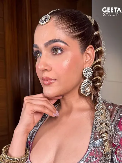 Showcasing our creative range with a modern and intricate bridal look. This features a sleek, high ponytail with elaborate braiding and a glowing, perfectly contoured makeup application, ideal for the bride who wants a unique and memorable style.