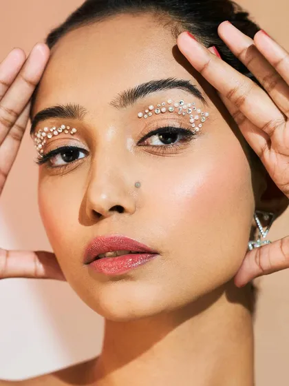 This portrait shows how embellished eye makeup can be both artistic and wearable. It's a modern way to add sparkle and drama.