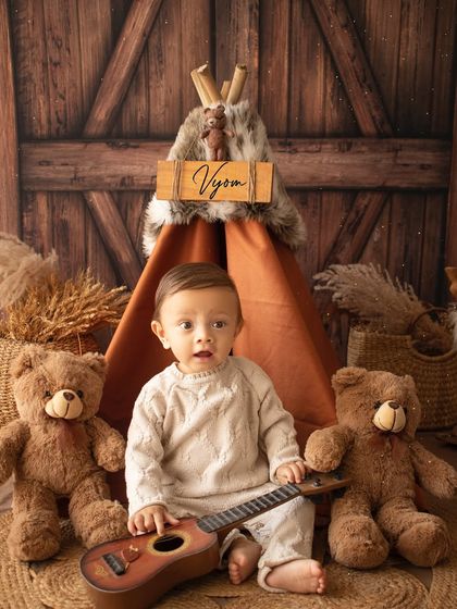 This little musician is ready to play! Using props like a ukulele adds a fun and interactive element to the photoshoot.