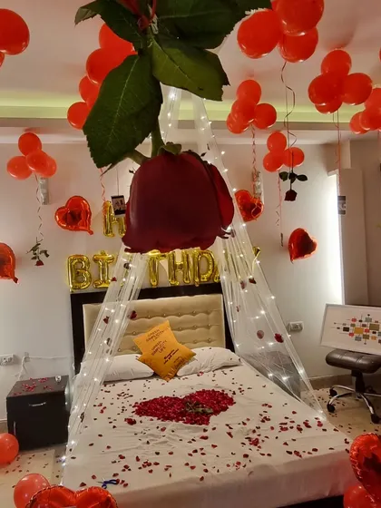 A creative shot looking up at the giant hanging rose and balloon-filled ceiling.