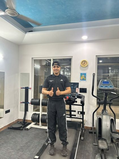 Thumbs up in the home gym setup.