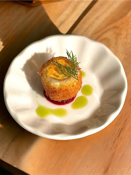 Every meal with us starts with an amuse-bouche, like this crispy goat cheese panna with a homemade port wine gel, designed to delight the palate.