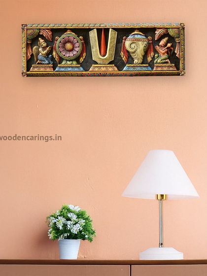 A multicolored wall panel featuring the Balaji Thirunamam, displayed in a modern living room setting.