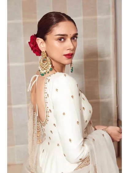 A beautiful back view of the white Jigar Mali Anarkali, accented with a red rose in the hair for a classic, romantic touch.