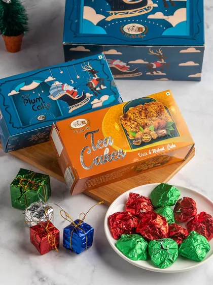 The 'Festive Joy' hamper, which includes a rich plum cake, assorted chocolate rocks, and a date and walnut tea cake.