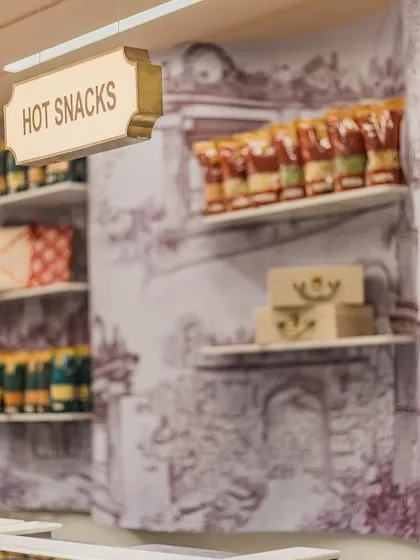 The curved wall behind the counter features artwork of the Gummanayaka fort, adding a layer of local Karnataka heritage to the store.