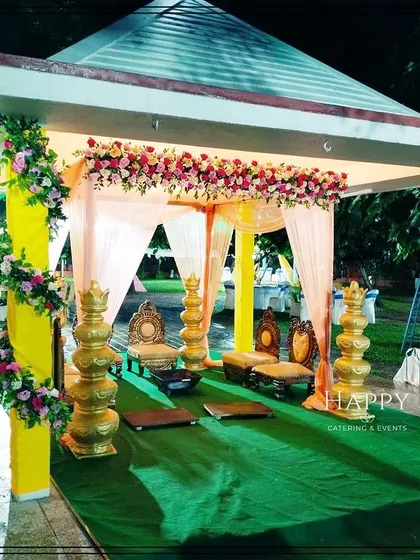 An intimate outdoor mandap setup nestled within a garden gazebo. This design blends traditional elements like brass lamps and floral arrangements with the beauty of nature, creating a serene and sacred space for your wedding ceremony.