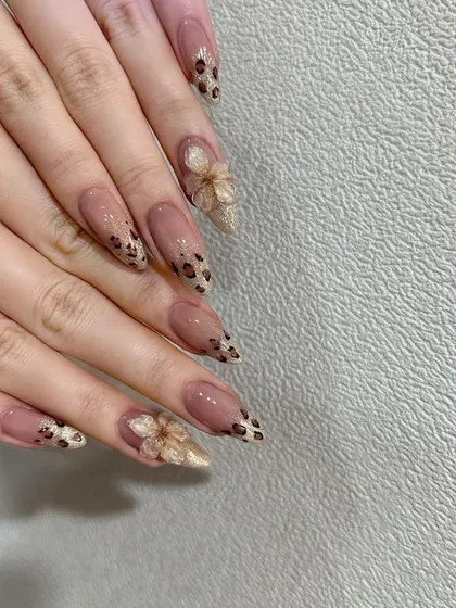 For a look that's both fierce and delicate, I hand-painted this leopard print on sharp, stiletto-shaped gel extensions. The design is balanced with a beautiful, sculpted 3D acrylic flower on the accent nail.