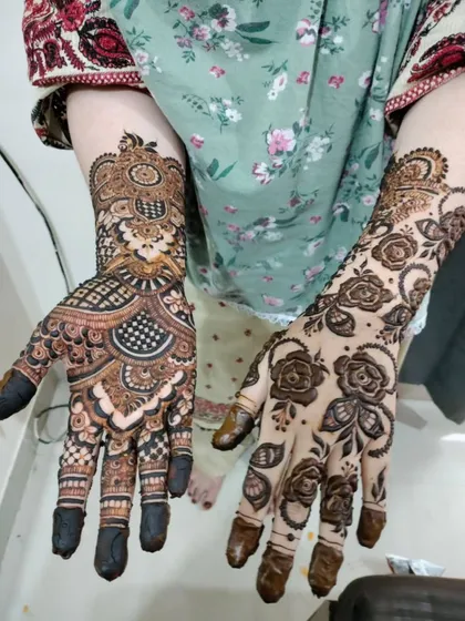 A bride showing off two different, yet complementary, designs on her hands. This is a great option for brides who want a unique look.