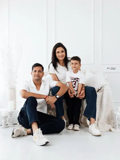 A classic seated family portrait with a toddler. Our all-white studio setup is versatile for creating both formal and casual family photos.