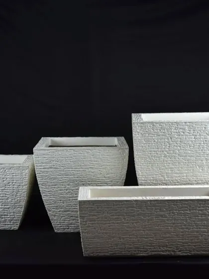Textured white fiber planters in different shapes and sizes. The rough texture adds a unique, rustic feel.