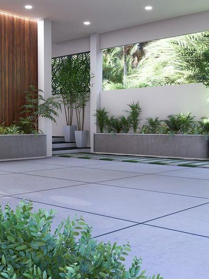 A wide view of the designed parking area, showing the clean tiled flooring, planters, and the wooden accent wall that elevates the space.