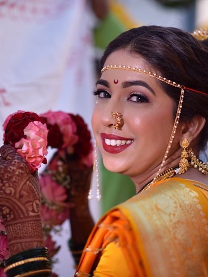 A classic bridal portrait. The bold red lip and defined eyes are hallmarks of a traditional look, making the bride look stunning and confident.