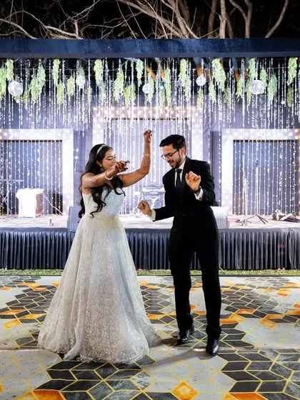 The couple's first dance on the beautifully lit stage. A classic and romantic moment.