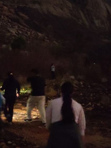 The night trek begins. Our group making their way up the hill in the dark, guided by torchlight.