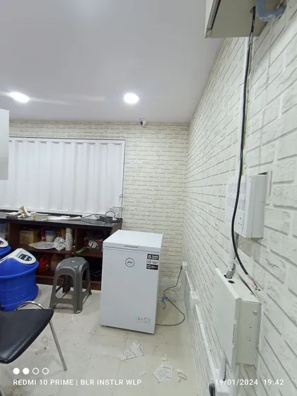 Another angle of the commercial kitchen installation. The white blinds match the brick-patterned wallpaper, giving the space a clean and bright feel while ensuring privacy.