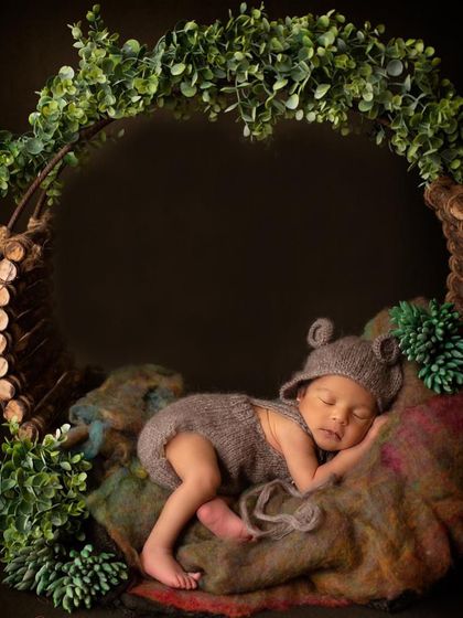 Bear-y sleepy and too cute to handle! This little one is nestled in a rustic wreath, dressed as a tiny bear, creating an enchanting, woodland-themed portrait.