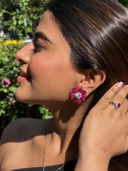 A closer look at the ruby floret earring and a matching ruby ring, creating a coordinated and powerful statement.