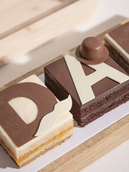 A special treat for a special hero. Our limited edition Father's Day dessert features handcrafted layers of cake and mousse, spelling out 'DAD' for a truly personal and delicious gift.