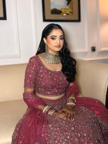 The complete reception look. The makeup perfectly complements her intricate lehenga and heavy jewelry without being overpowering.