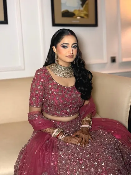This bride is the picture of elegance for her reception. The makeup is radiant and polished, designed to last all night long as she celebrates with her loved ones.