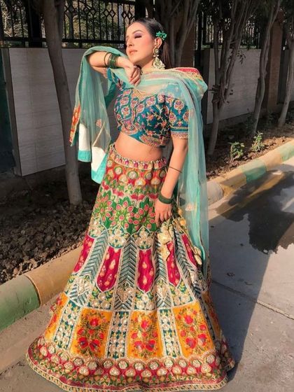 A different pose in our popular multi-color lehenga, showing its beautiful flare and the way the light teal dupatta complements the vibrant skirt.