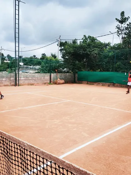 Junior players engaged in a competitive doubles match during an AITA U-14 tournament, showing the dynamic play and teamwork fostered at my events.