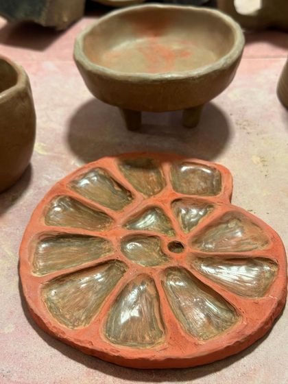 A terracotta paint palette, ready for the kiln. The shell-like shape and the smooth indentations are both beautiful and functional.