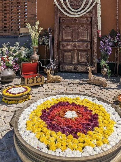 A beautifully decorated entrance for the Unnati launch event, with traditional flowers and instruments.