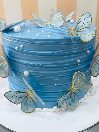 A full view of the stunning blue butterfly cake, perfect for a magical birthday celebration.