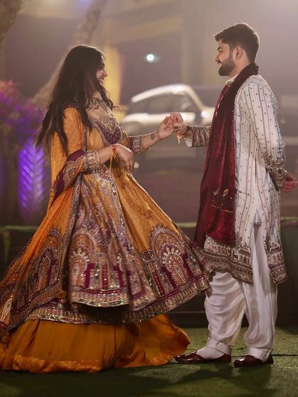 A twirl at our Mata Ki Chowki function. His classic white kurta-pajama with a deep red shawl provides a regal counterpoint to my heavily embroidered mustard and maroon Anarkali.
