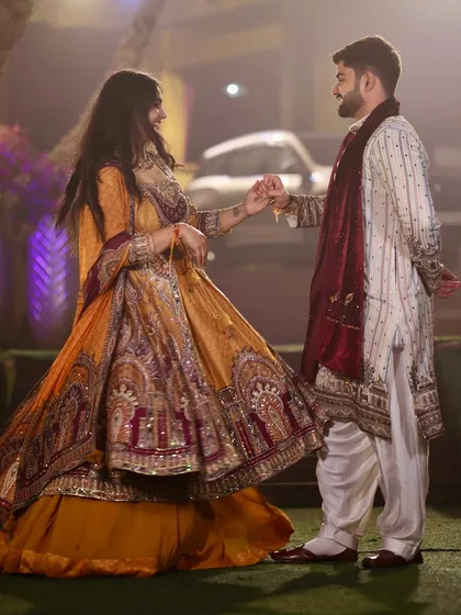 A twirl at our Mata Ki Chowki function. His classic white kurta-pajama with a deep red shawl provides a regal counterpoint to my heavily embroidered mustard and maroon Anarkali.