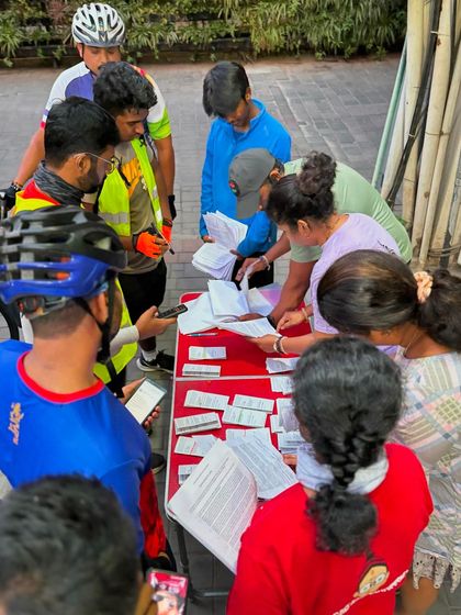 Volunteers and riders at the registration table for the 100K BP, a crucial part of organizing a smooth event.