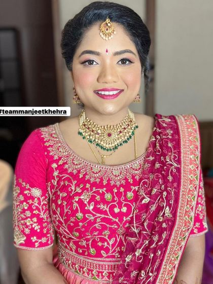 The bride's sister deserves to shine too. For her sister's Muhurtham, I created this fresh and pretty look with pink and silver eyeshadow, a bright pink lip, and a braided hairstyle, all complementing her beautiful pink lehenga.
