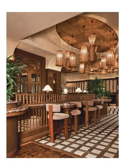 A shot from the Architectural Digest feature on One 8 Commune in Hyderabad. This view showcases the interplay of my custom teakwood vitrified tiles and the intricate wooden architectural details, creating a warm and sophisticated dining environment.