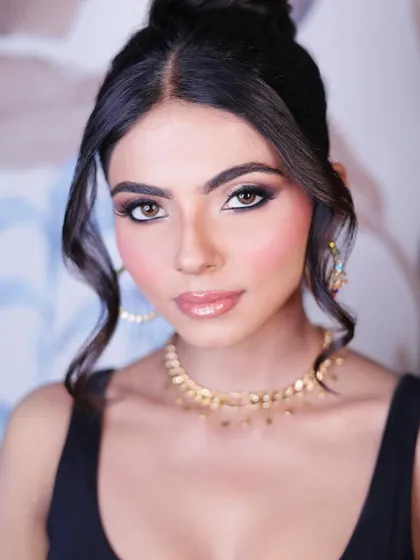 A direct, confident gaze. This close-up highlights the sharp winged eyeliner and perfectly defined brows, key elements of a polished party makeup look.