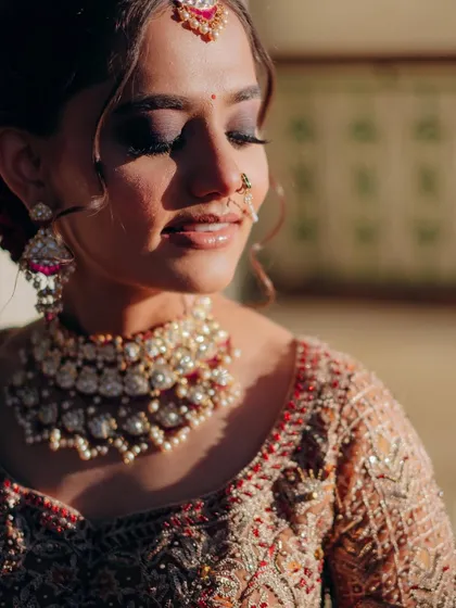 Golden hour perfection. The warm sunlight kisses her skin, accentuating the glow and the masterful blend of her smokey eye makeup.