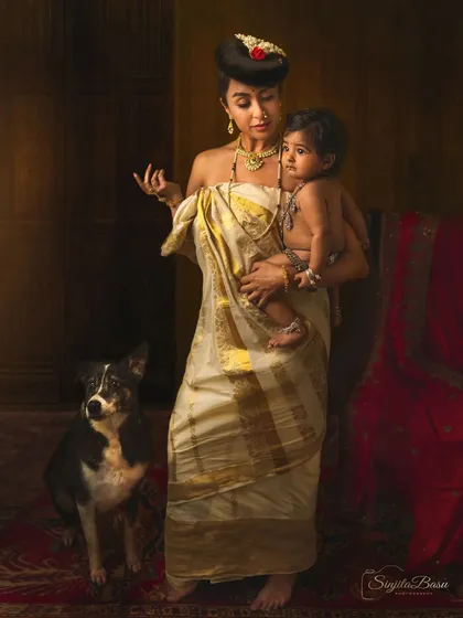 A duplicate of image 67, this portrait is a modern reinterpretation of a Raja Ravi Varma painting. It showcases how we can draw inspiration from classical art to create something new and personal, celebrating both motherhood and our love for pets.
