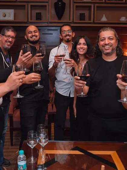 Cheers! A celebratory moment with the whole crew. We're more than a band; we're a family that loves making music together.