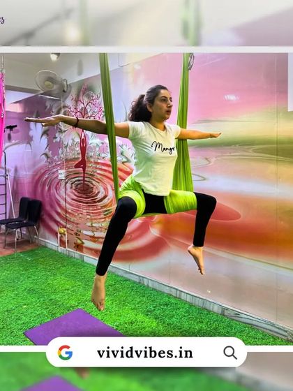 Elevate your yoga practice and feel the freedom. This student is enjoying a moment of flight, her arms spread wide.