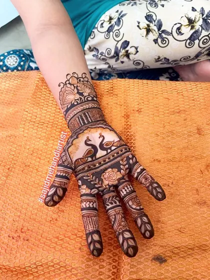 Mastering classic motifs is essential. This design showcases the elegant peacock, a favorite in bridal mehandi, combined with detailed finger work and shading techniques that I cover thoroughly in my classes.