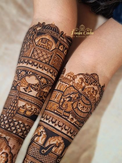 A close-up of a bridal start-up, showing the intricate details of the forearm design, including peacocks, elephants, and architectural motifs.