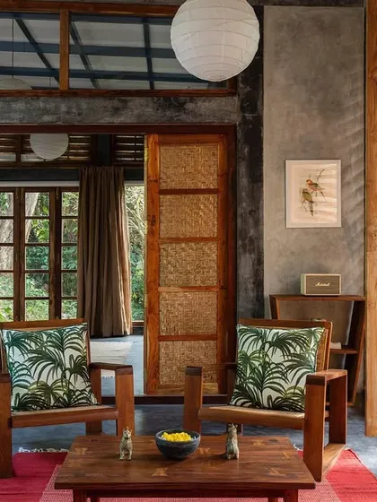 The living room of the private villa, showing the woven teak screens that can be opened or closed. This allows residents to control the amount of light, air, and privacy they desire.