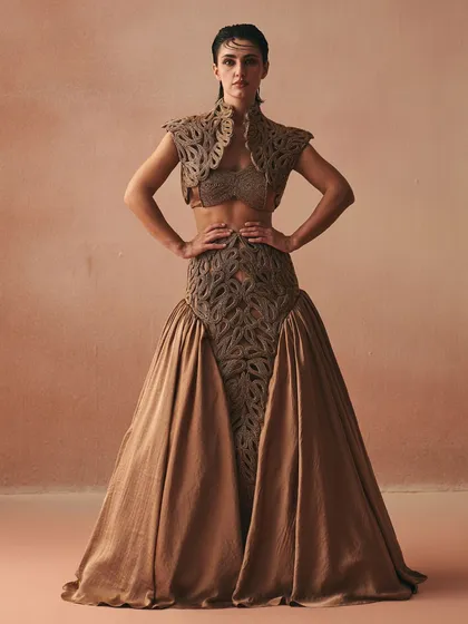 This ensemble features a full-volume skirt and a matching cropped jacket, both defined by intricate cordwork. The centerpiece is the structured bralette, showcasing how I use corsetry to build a powerful, layered look.