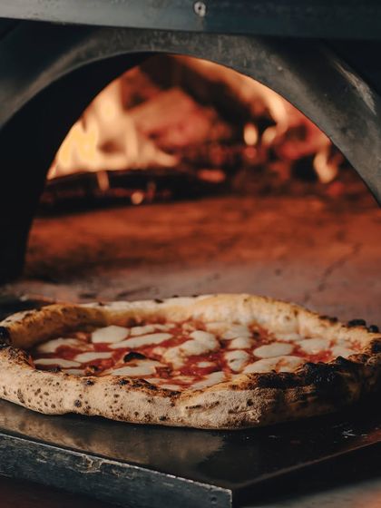 Another shot of our pizza in the oven, because we can't get enough of that fiery glow.