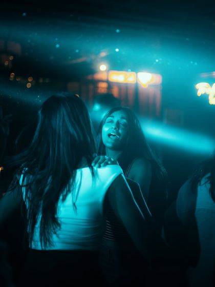 Two friends sharing a happy moment on the dancefloor.