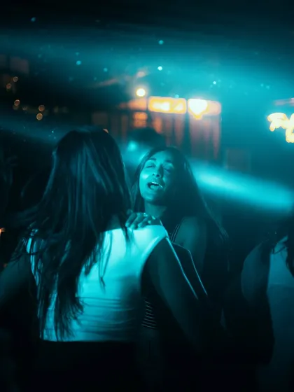 Two friends sharing a happy moment on the dancefloor.
