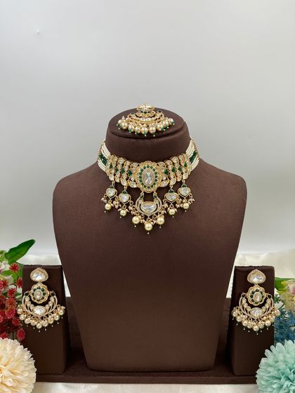 This collection showcases our premium Moissanite Kundan necklaces like the 'Noor Nazaakat' and 'Darbaar' sets. Each comes with a full set of earrings and maang tikka, available in various color combinations.