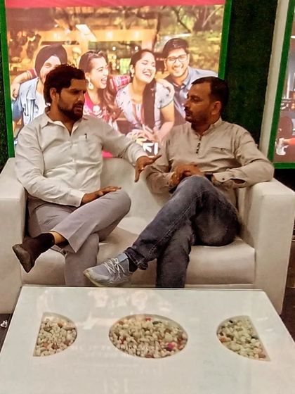 In conversation with a friend. The caption wisely notes, "Complaints also have their own dignity; they are not made to just anyone."