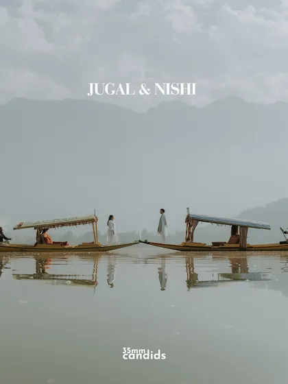 Two shikaras meet on the calm waters of Dal Lake. This pre-wedding shoot in Kashmir was about capturing serenity and connection, using the iconic landscape to mirror the couple's peaceful and profound love.